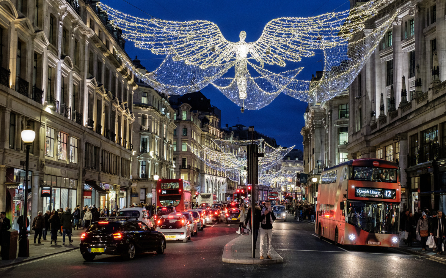 Regent Street in London with Christmas lights and buses.