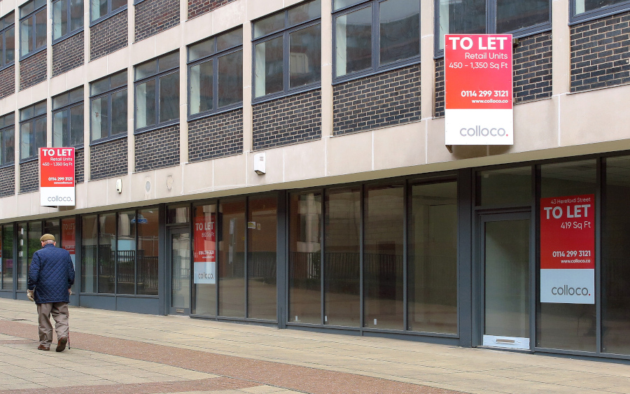 A large office building with signs indicating that it is to let.