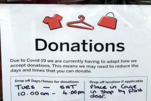 A sign saying a charity shop has had to limit arragements for taking donations.