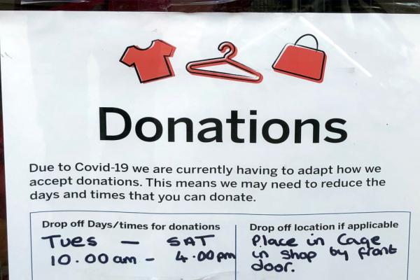 A sign saying a charity shop has had to limit arragements for taking donations.