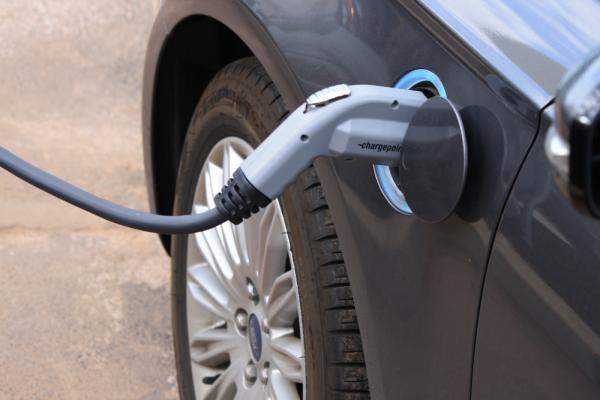 A close-up of an electric vehicle charging.